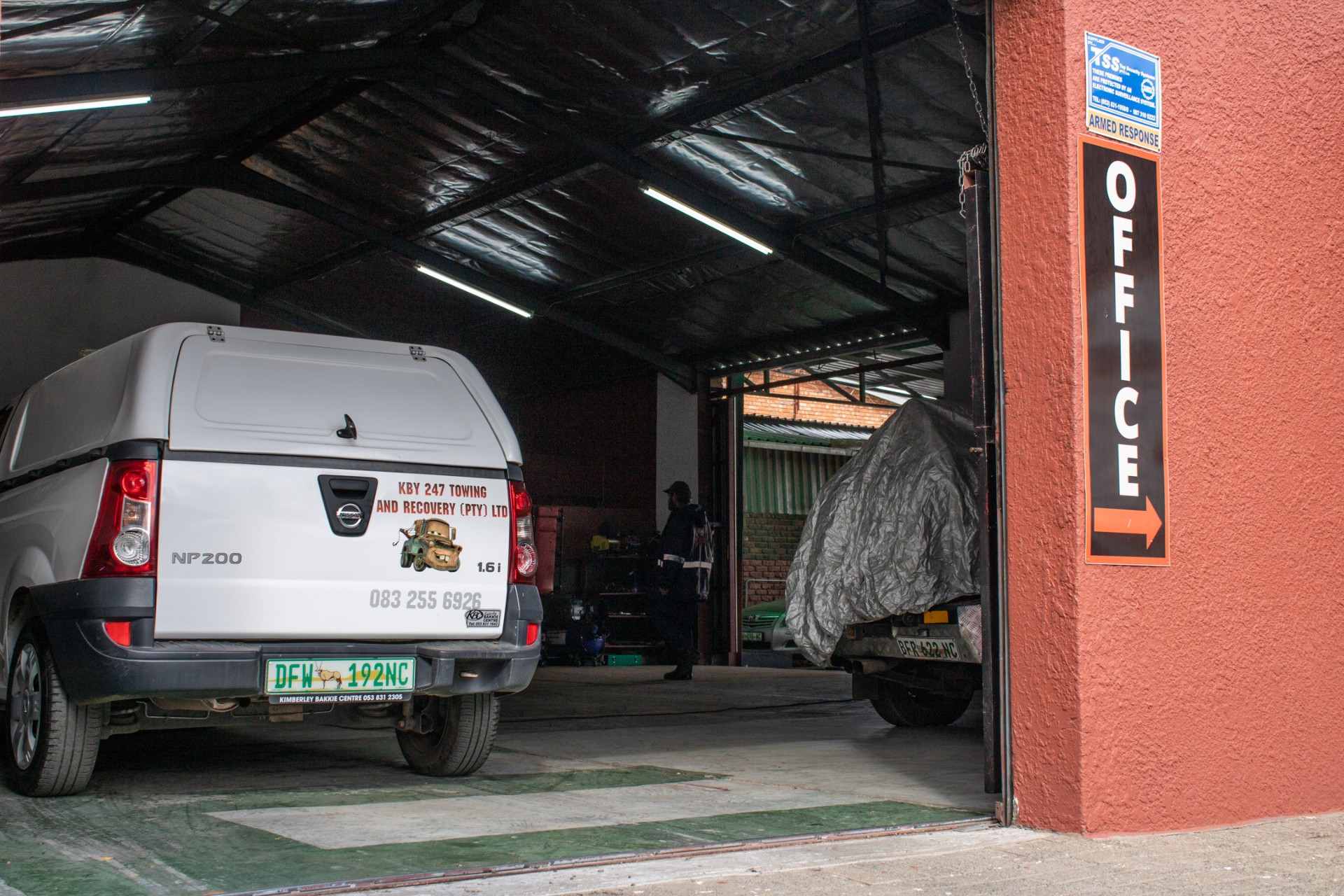 Inside the KBY 247 workshop bay with vehicles being serviced