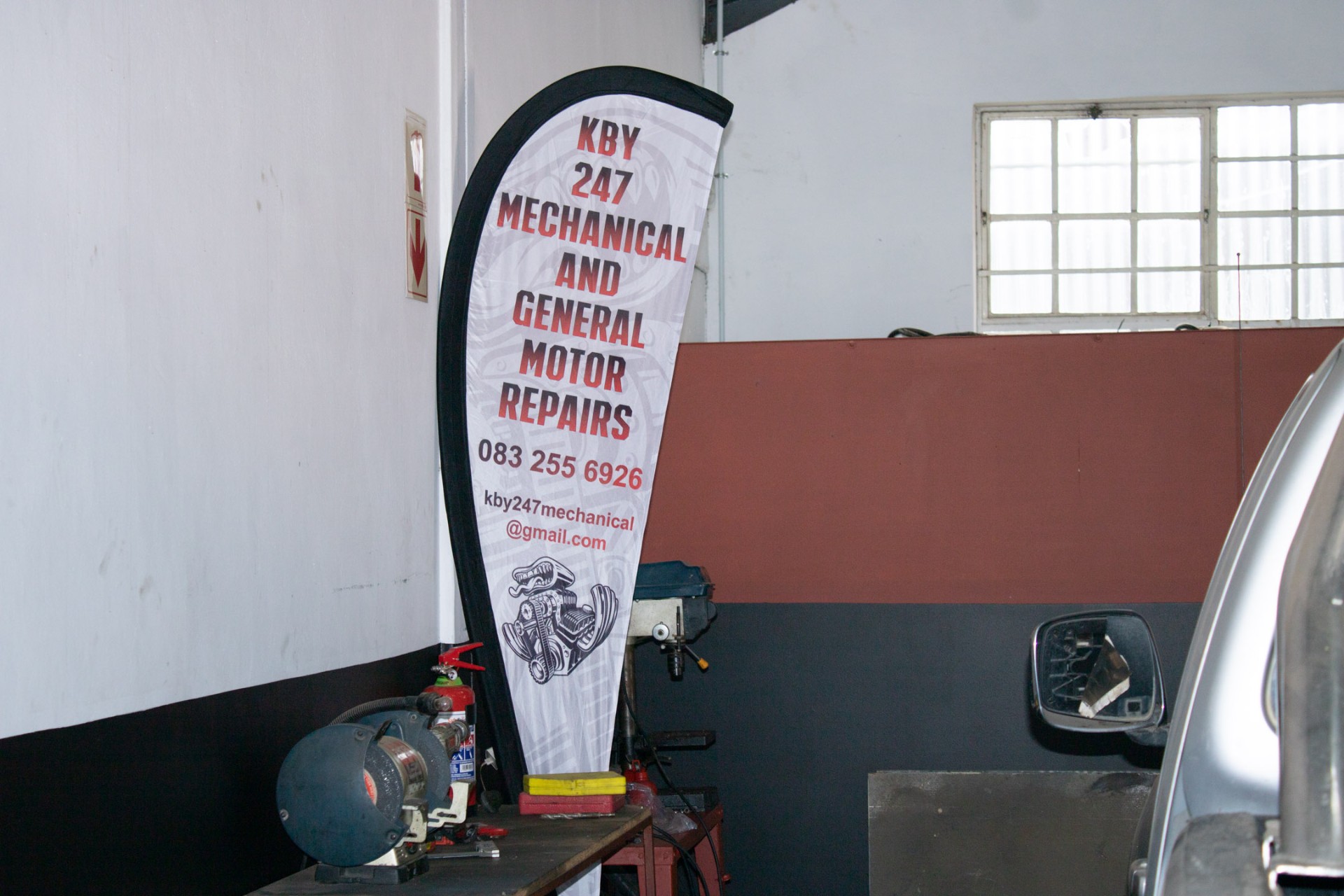 KBY 247 Mechanical and General Motor Repairs banner inside the workshop